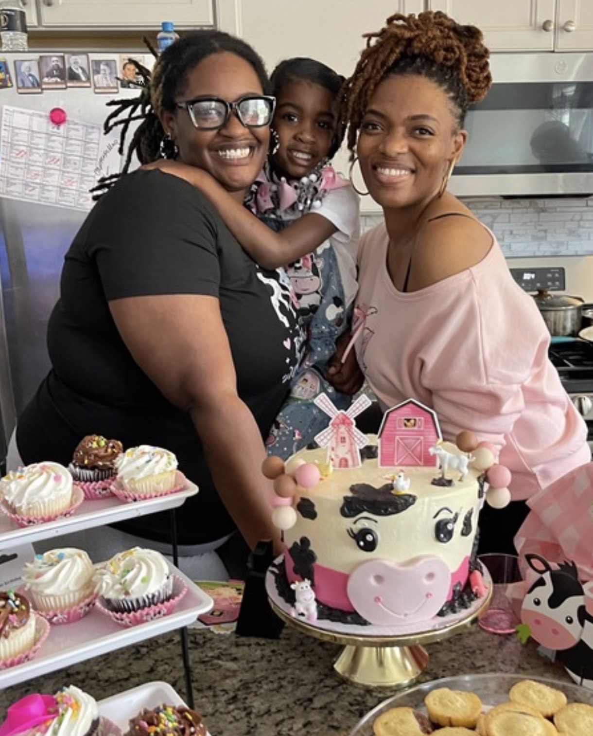 Pink farm-themed birthday cake with family