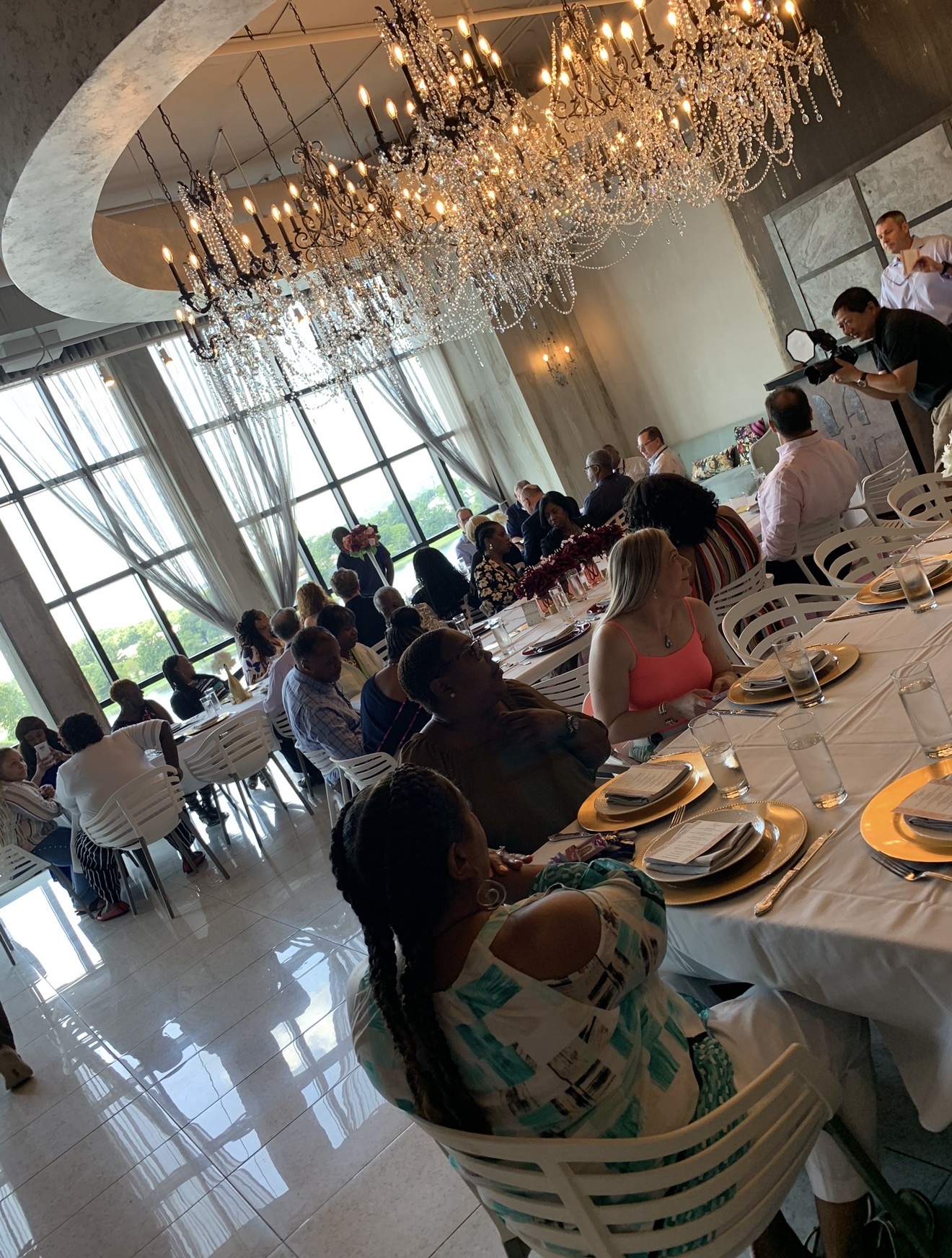Chandelier dinner reception with waterfront view